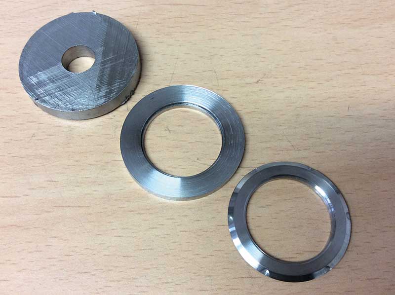 Figure 9. Three different stages of machining a watch case part.